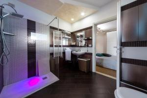 a bathroom with a shower with a pink light in it at B&B Palazzo del Toro in Montesilvano