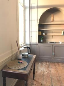 um quarto com uma mesa de madeira e um banco em Mercier de Montigny - Les Chambres du Beffroi - SPA et Massage em Fougères