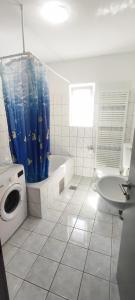 a bathroom with a tub and a toilet and a sink at Apartmani Kevric in Novi Vinodolski +43 photos