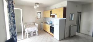 a small kitchen with a table and a counter top at Apartmani Kevric in Novi Vinodolski