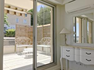 a room with a balcony with a table and chairs at Appartement 'Eucalyptus' in Nice