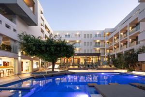 a swimming pool in the middle of a building at Atrium Ambiance Hotel in Rethymno Town