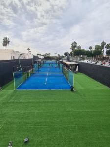 a row of tennis nets on a tennis court at Renovated House Front-Pool in Maspalomas