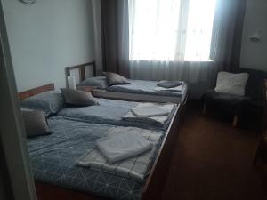 Postel nebo postele na pokoji v ubytování Hotel Olimpijski