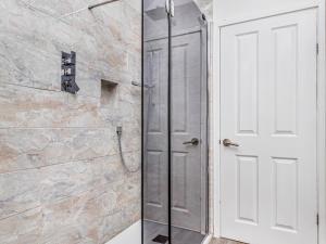 a shower with a glass door in a bathroom at Pass the Keys Charming Annexe w Garden Parking Pass The Keys in Chichester
