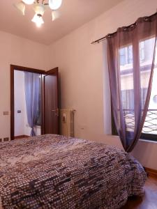 a bedroom with a bed and a window at Loft Garibaldi in Correggio