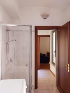 a bathroom with a shower with a glass door at Loft Garibaldi in Correggio