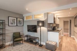 a kitchen with a table and a chair in a room at Nelson Crescent East : Modern one bedroom basement apartment in central location in Kent