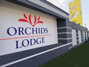 Una señal para una oficina de orquídeas en Londres en Orchids Lodge, en Fourways