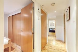 a hallway with a wooden door in a room at *Amazing Location!*In heart of the City. 2BR & Cot in Edinburgh