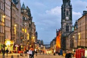 a city street with a clock tower and people walking at *Amazing Location!*In heart of the City. 2BR & Cot in Edinburgh