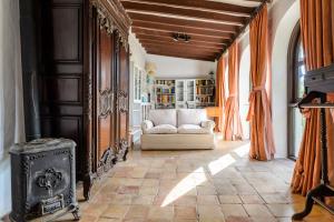 a living room with a couch and a wood stove at Villa Can Sarrio in Sant Carles de Peralta +31 photos