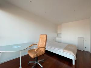 a bedroom with a bed and a desk and a chair at Panoramic Apartment Vilnius in Vilnius