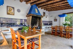 a dining room with a table and a fireplace at Villa Can Sarrio in Sant Carles de Peralta