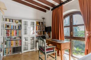 a home office with a desk and book shelves at Villa Can Sarrio in Sant Carles de Peralta