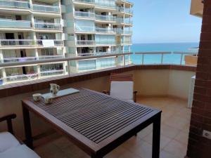 a balcony with a table and a view of the ocean at ACV Primera Línea in Oropesa del Mar +40 photos