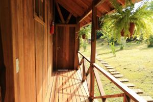 an open door of a wooden house with a porch at Posada Camboatá in Aristóbulo del Valle +59 photos