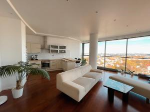 a living room with a couch and a table at Panoramic Apartment Vilnius in Vilnius