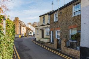 an empty street in a town with brick houses at Brook Cottage in Temple Ewell