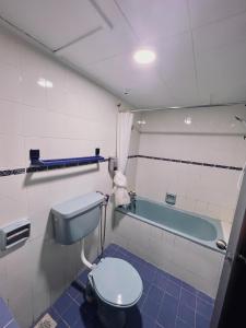 La salle de bains est pourvue de toilettes et d'une baignoire. dans l'établissement Blossom Silverpark Apartment, à Bukit Fraser