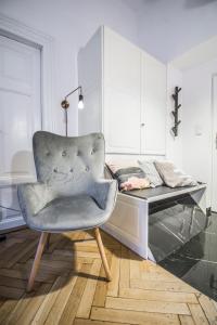 a bedroom with a chair and a desk at LION apartments in Krakow