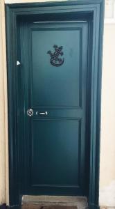 a green door with a snake painted on it at New Apartment in the Heart of Le Marais in Paris