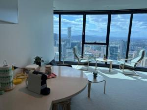 a living room with a table and chairs in a building at Amazing views 60th level skytower 3 bedrooms in Brisbane