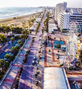 an aerial view of a beach with a ferris wheel at Hai Hotel in Larnaca