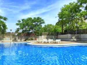 a swimming pool with lounge chairs and a swimming pool at Arquus Park in Salou