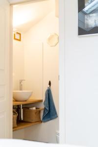 a bathroom with a sink and a mirror at Au four et au jardin in Namur +35 photos