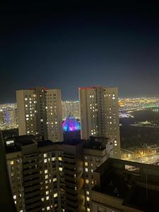 a view of a city at night with buildings at Happy Days at Highvill G in Promyshlennyy