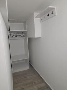 um quarto branco com uma prateleira e uma parede branca em K&K Luxury Loft Apartment em Serres