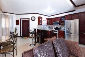 a kitchen with a couch and a table and a refrigerator at Loft - Sleeps 4 - Parking - Balcony in Kingston +4 photos