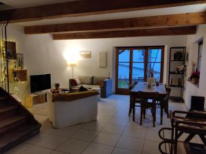 a living room with a couch and a table and chairs at Au Grès des Vignes in Turckheim