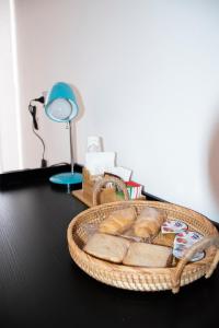 a basket of bread sitting on a table with a lamp at Maison L'amuri in Palermo
