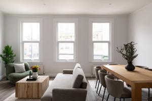 a living room with a table and chairs at The Fulham Secret - Classy 5BDR Apartment in London