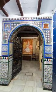 an archway in a building with a painting on the wall at Casa Tenorio Barrio de Santa Cruz in Seville