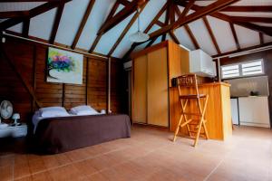 a bedroom with a bed and a ladder in a room at Nature Paradise Pool & Spa - Exceptional Secluded Luxury Location in Le Diamant