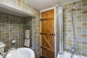 a bathroom with a shower and a toilet and a sink at Taylors Townhouse in Royal Tunbridge Wells