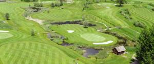 an overhead view of a golf course with a pond at Ferienhaus Kirchbach in Kirchbach