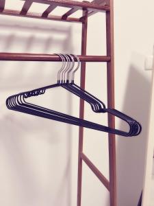 a wooden shelf with a hanger on it at 32Sqm 1000x500wifi workplace long stay in Amphoe Phra Khanong