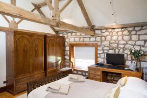 a bedroom with a bed and a tv on a desk at Crow House Barn in Copgrove