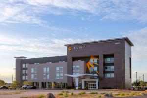 a building with a painting on the front of it at La Quinta Inn & Suites by Wyndham Maricopa Copper Sky in Maricopa