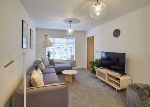 a living room with a couch and a flat screen tv at Host & Stay - Hoggarths Retreat in Whitby