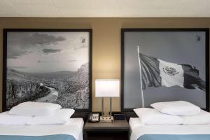 a hotel room with two beds and a flag at Super 8 by Wyndham Laredo in Laredo