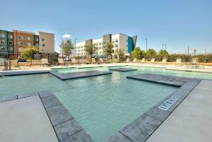 a large swimming pool with blue water in a building at La Quinta Inn & Suites by Wyndham Lubbock Southwest in Lubbock