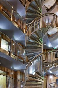 a spiral staircase in a building with wooden walls at The Z Hotel Soho in London