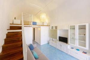 a living room with a loft bed and a television at TORRETTA CORRICELLA - Punta Miseno in Procida