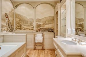 a bathroom with a mural of animals on the wall at The Welcombe Golf & Spa Hotel in Stratford-upon-Avon