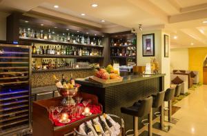 a bar in a restaurant with a counter with drinks at Best Western Green Hill Hotel in Yangon